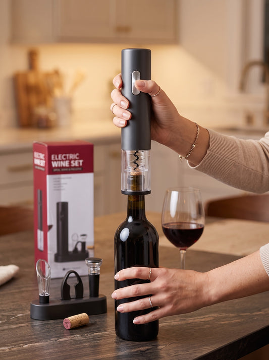 Electric wine opener gift set uncorking a red wine bottle on a kitchen table