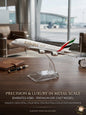 Emirates A380 model airplane on a stand with a background of an airport terminal.