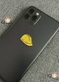 Black phone case with a yellow hard hat design on a gray textured background