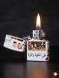 Lighter with a design of a scene and Arabic text, lit on a dark background