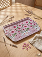 Decorative tray with floral design on a wooden table