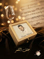 Wooden box with a portrait and microphone on sheet music, warm lighting