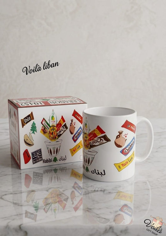 Mug with Lebanese-themed design next to its packaging on a marble surface.
