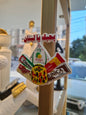 Decorative sign with various brand logos on a wooden stand