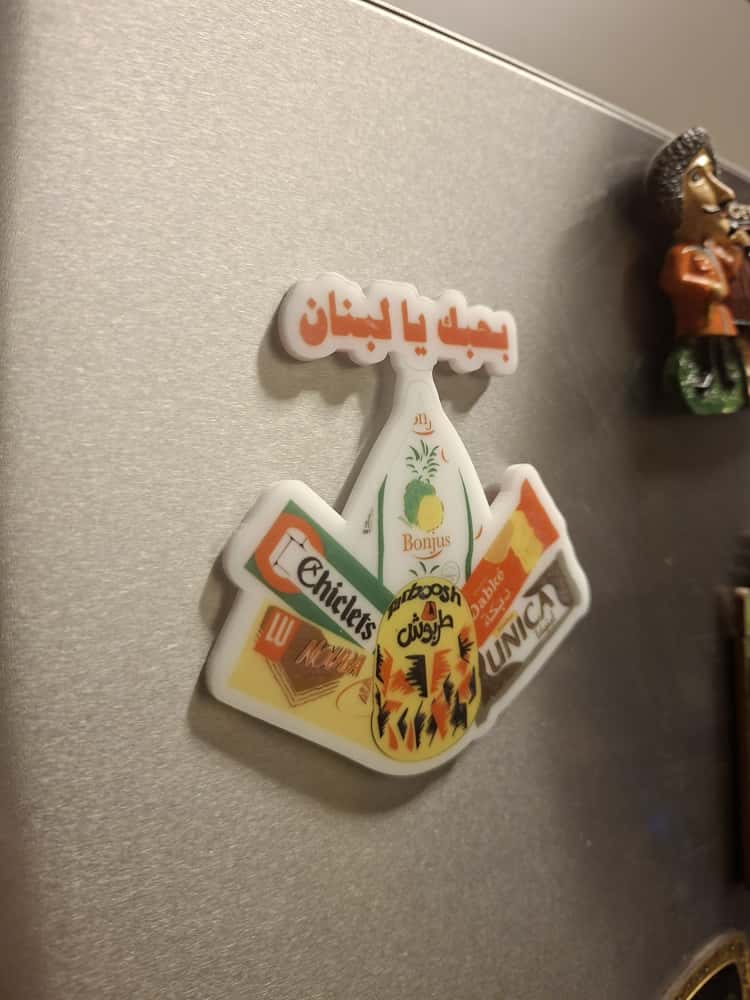 Decorative refrigerator magnet with colorful design on a metallic surface