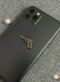 Phone case with a gun-shaped design on a textured surface