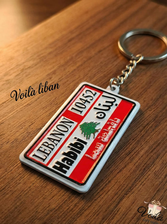 Keychain with Lebanese design on a wooden surface