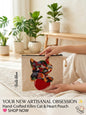 Woman sitting in a sunny room holding a premium hand-crafted kilim tapestry pouch featuring a colorful woven cat resting on a large red heart.