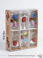 Set of six authentic hand-painted Lebanese glass tea cups featuring traditional red tea cup illustrations and colorful banners with Arabic greeting calligraphy like Ahlan wa Sahlan, in a premium display box.