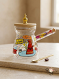 Hand-painted glass Lebanese coffee rakweh with dried flowers in the handle and a gold spoon
