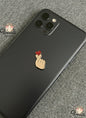 Phone case with a hand and heart design on a gray surface, branded 'Voila'.
