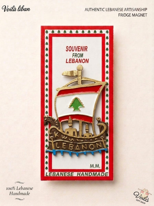 Authentic 100% handmade Lebanese fridge magnet featuring a sculpted metallic Phoenician ship with a Lebanese flag sail riding blue waves, in premium souvenir packaging.