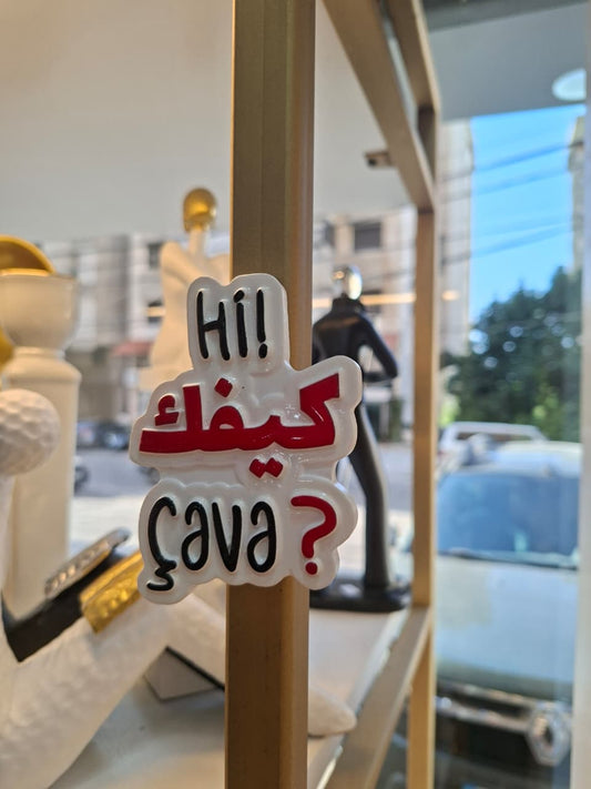 Decorative sign with Arabic text and English greeting in a store setting