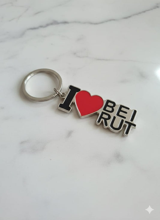 Keychain with 'I ❤️ BEI RUT' text on a marble background