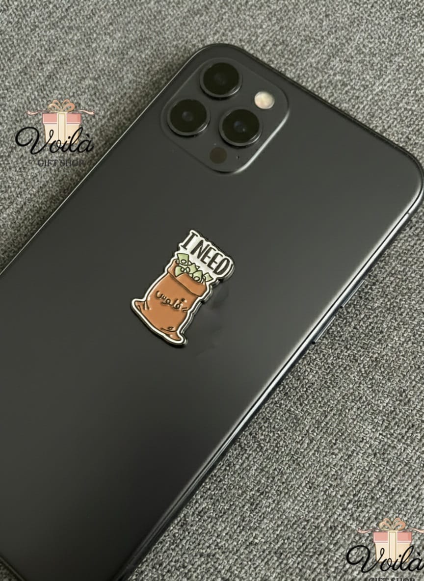 Phone case with a coffee cup design and 'I need coffee' text on a gray surface.