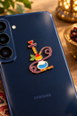Vibrant enamel Lebanese argileh shisha charm affixed to the back of a blue smartphone