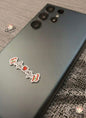 Phone case with 'The Camp' branding on a textured surface