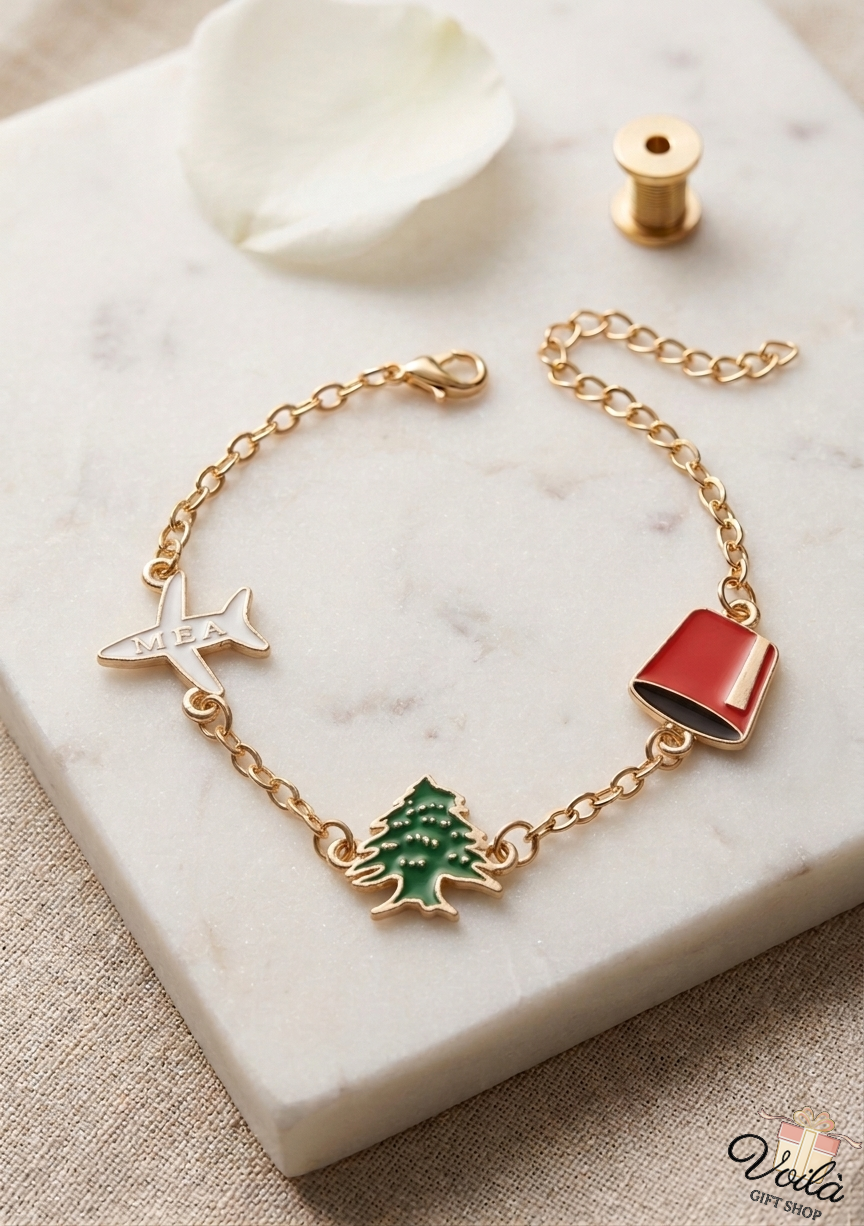 Gold-tone bracelet with white MEA airplane, green cedar tree, and red tarboush enamel charms