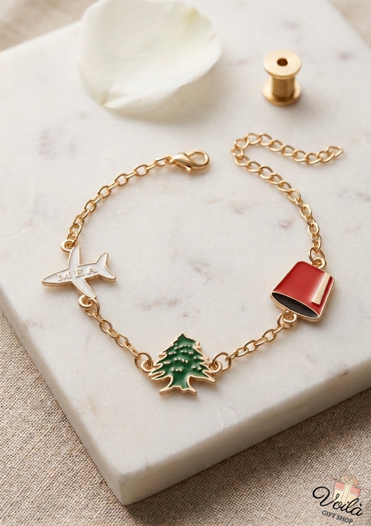 Gold-tone bracelet with white MEA airplane, green cedar tree, and red tarboush enamel charms