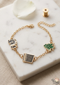 Gold chain bracelet featuring Lebanese cedar, Baalbek pillars, and Lebanon map charms