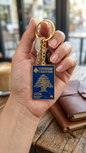 Premium blue and gold Lebanese passport replica keychain held in hand