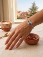 Silver beaded bracelet with a blue enamel Lebanese triple arch charm worn on a wrist