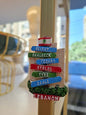 Decorative sign with names of Lebanese cities on a stick, blurred background