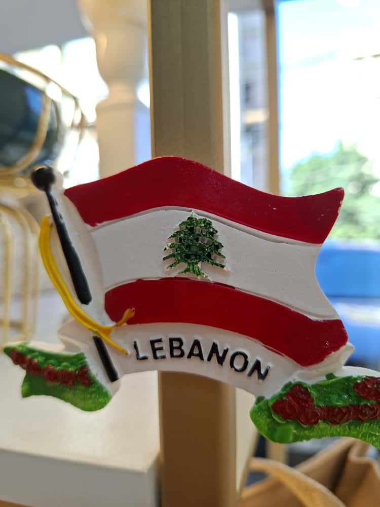 Lebanese flag ornament with 'LEBANON' text on a blurred background