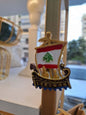 Decorative item with a ship design featuring the Lebanese flag on a stand.