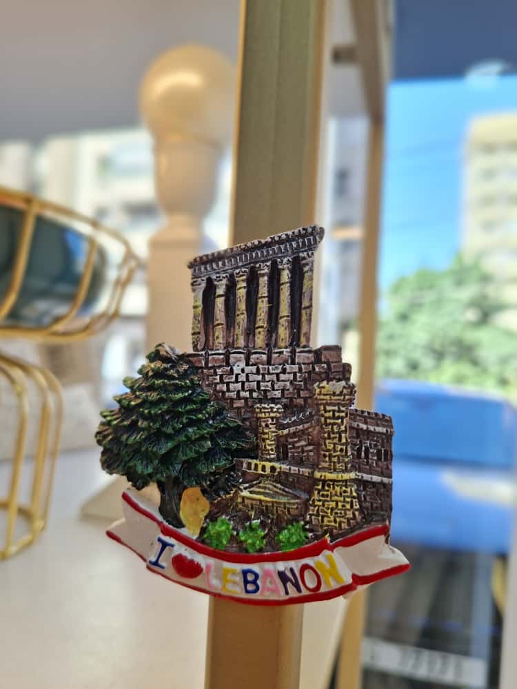 Fridge magnet with architectural design Lebanon' text, blurred indoor background