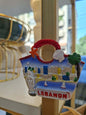 Decorative item with a scenic view of Lebanon on a stand.