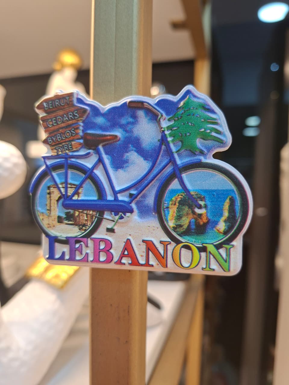 Fridge magnet with bicycle design and 'Lebanon' text on a stand.