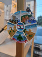 Decorative spinner with images of Lebanese landmarks and the Lebanese flag.