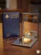 Lebanese passport and a compact mirror on a wooden surface