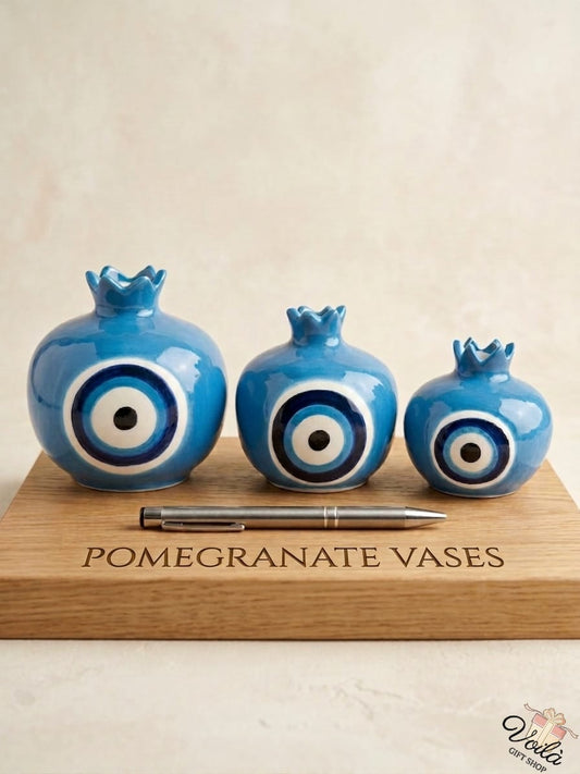 et of three premium light blue ceramic pomegranate vases in cascading sizes, featuring a striking traditional concentric circle motif, displayed elegantly on a wooden board.