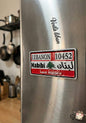 Metallic surface with a Lebanese license plate-style magnet and 'Vela Liban' branding.
