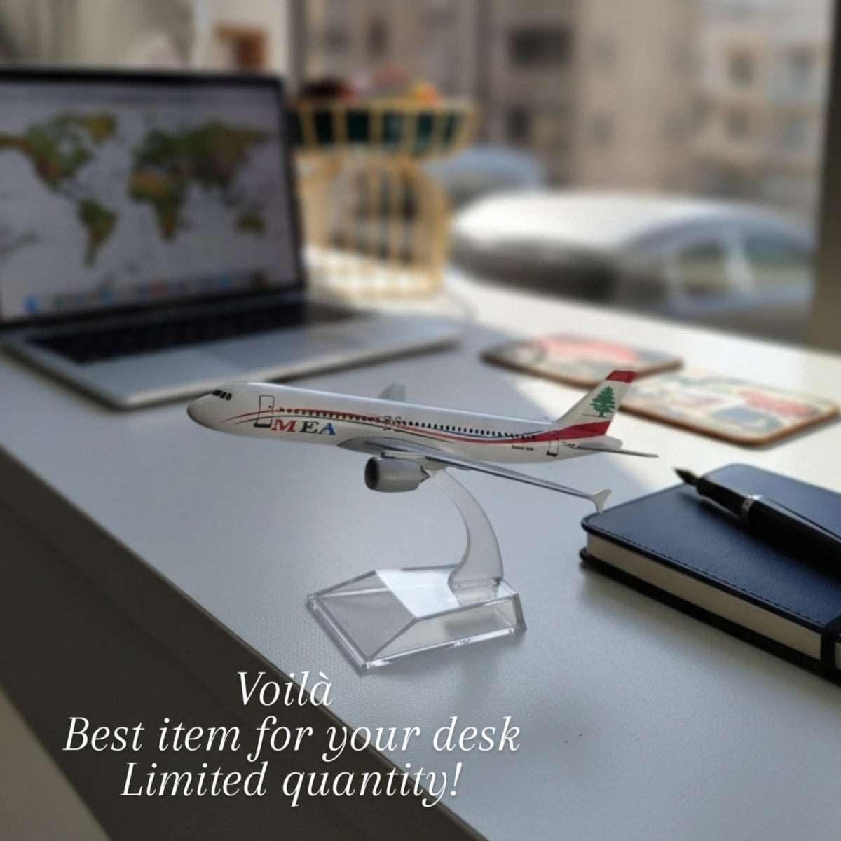 Model airplane on a desk with a laptop and notebook, promotional text overlay.
