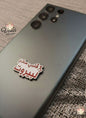 Phone case with Arabic text and 'Voila Gift Shop' branding on a textured surface