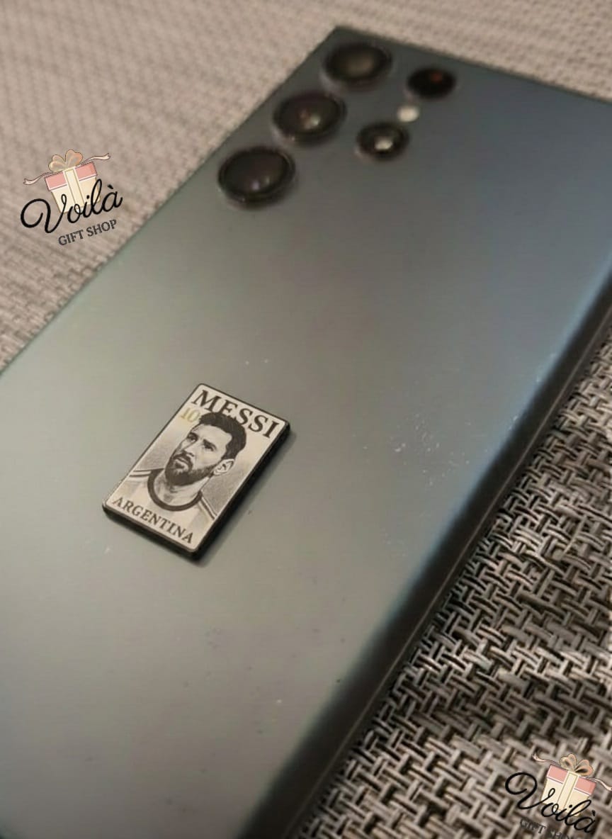 Phone case with Messi Argentina logo on a textured surface