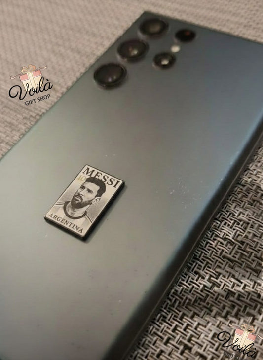 Phone case with Messi Argentina logo on a textured surface