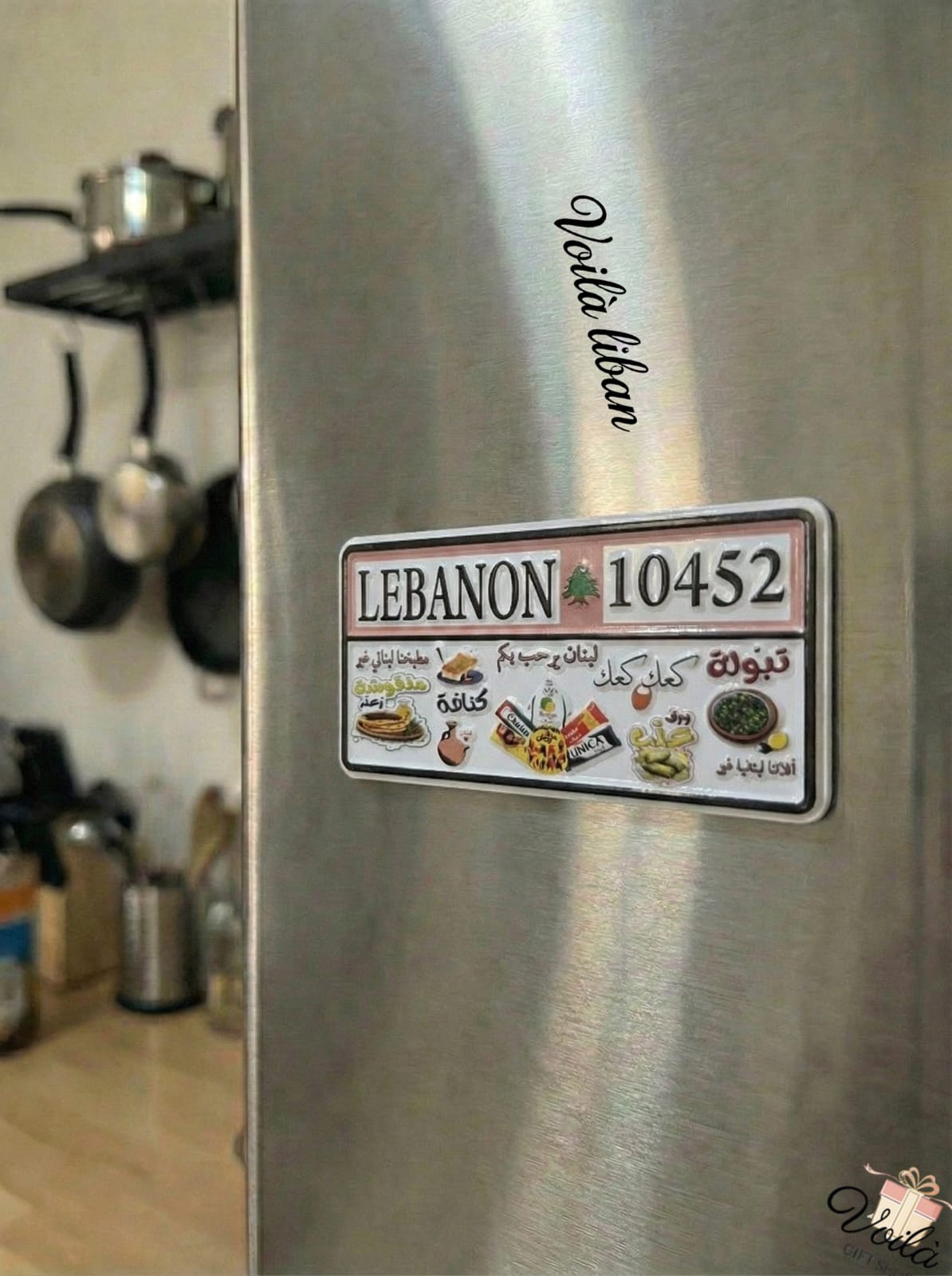Stainless steel refrigerator with a 'Lebanon 10452' magnet in a kitchen setting.