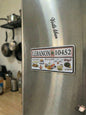 Stainless steel refrigerator with a 'Lebanon 10452' magnet in a kitchen setting.