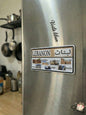 Fridge with a 'Lebanon' themed magnet featuring images and text on a kitchen background.