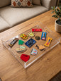 Clear acrylic serving tray with nostalgic Lebanese snacks and cultural icons