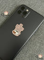 Phone case with 'But first coffee' design on a textured surface
