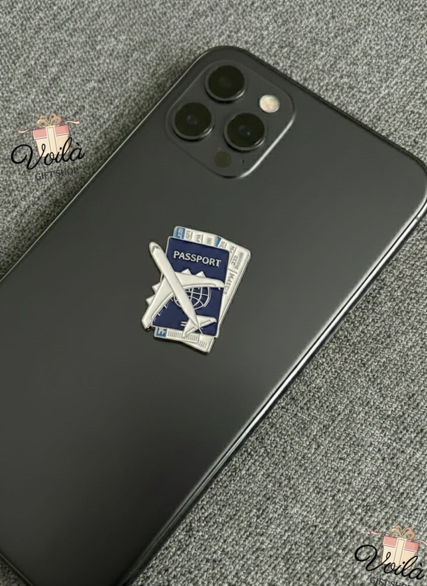 Phone case with passport and airplane design on a gray surface