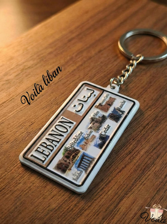 Keychain with a design of a Lebanese license plate on a wooden surface