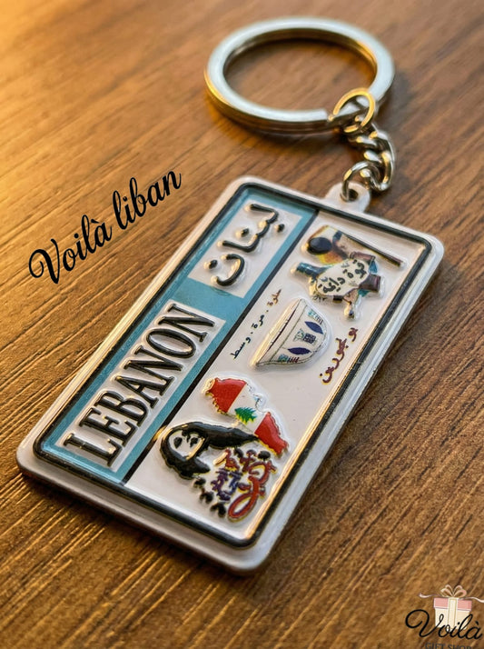 Keychain with Lebanese design on a wooden surface