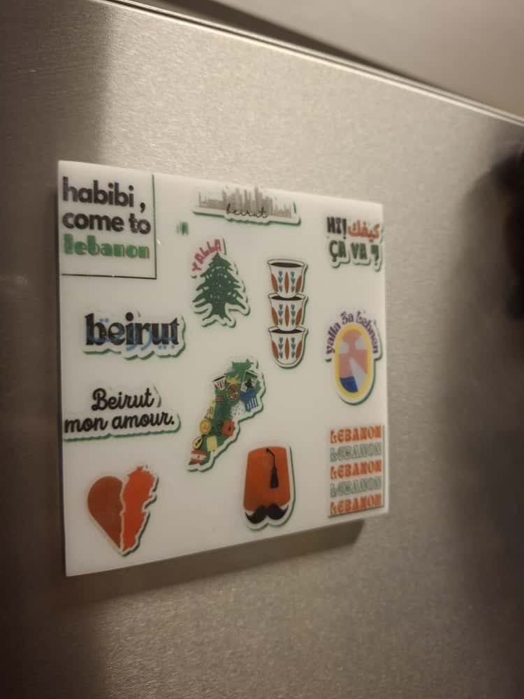 Set of stickers on a magnetic board with various designs and text.