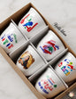 Set of six premium white ceramic Arabic coffee cups featuring vintage Beirut themes, retro colorful typography, and classical Lebanese portrait art, presented in a kraft display box.